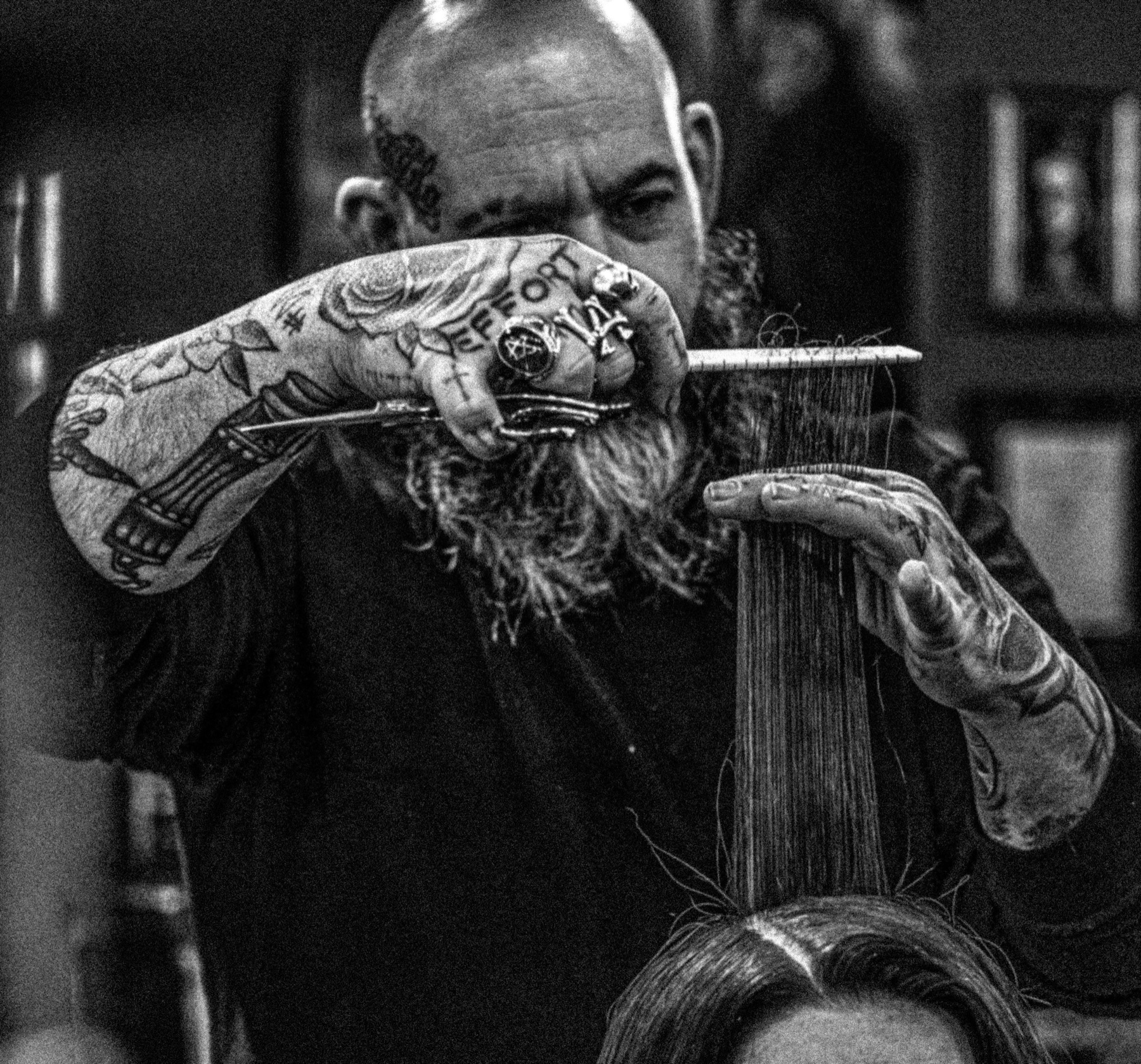 Damian Philpott precision cutting hair in black and white