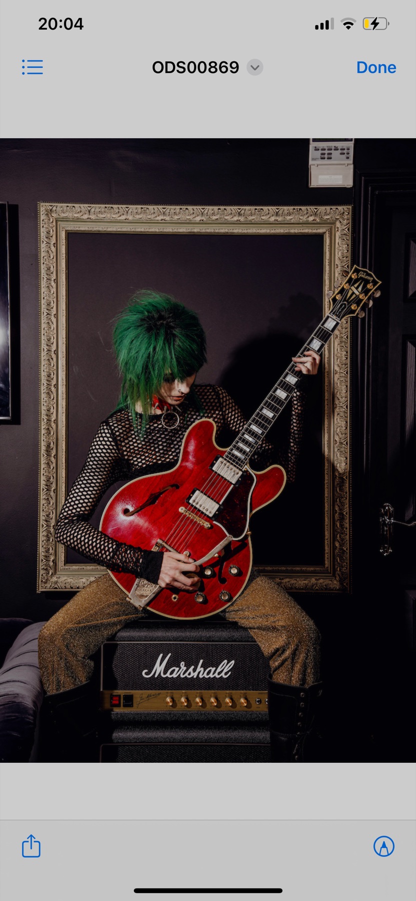 Creative green hair editorial portrait with a guitar