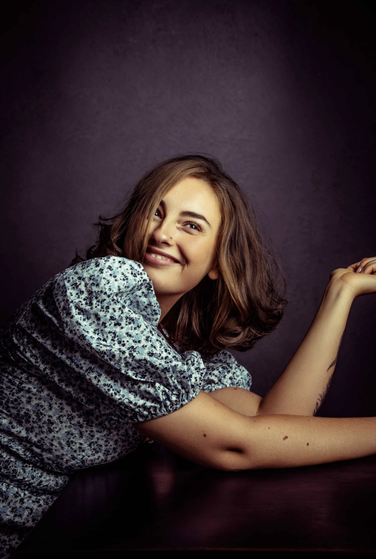 Smiling brunette editorial portrait with soft, polished movement