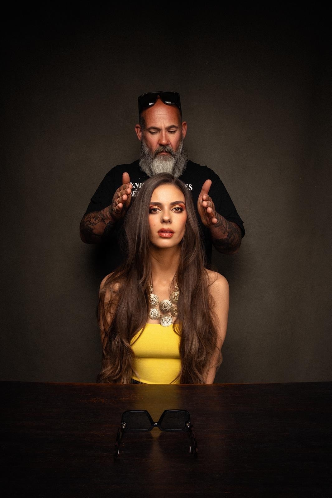 Damian assessing a client's finished hair
