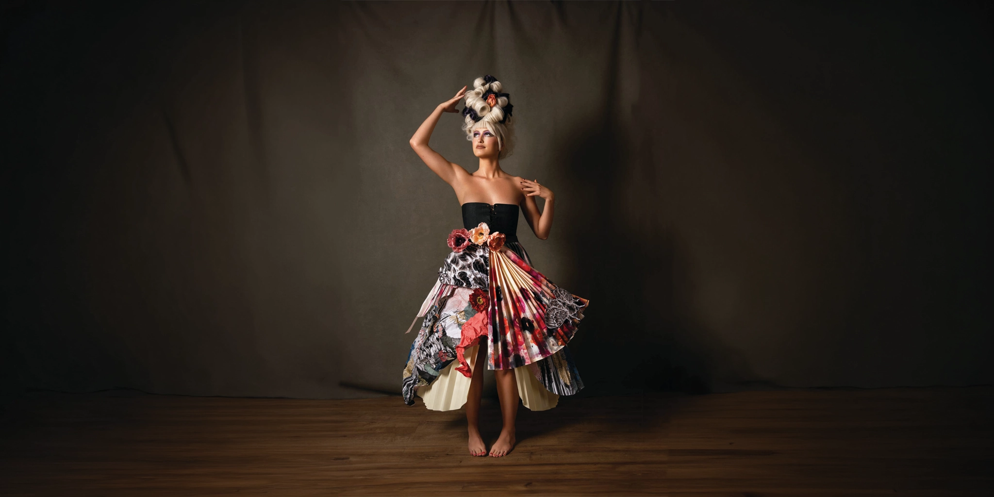 Editorial hair creation with sculptural styling and floral detail